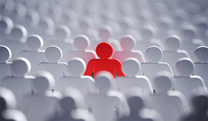 field of white human shaped forms, soft focus, one form is red 